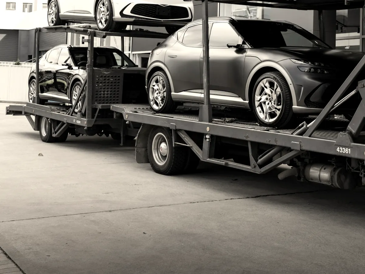 Keturi automobiliai sukrauti dviem aukštais ant autovežio priekabos